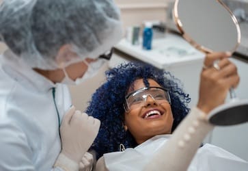 Patient looking at teeth in mirror